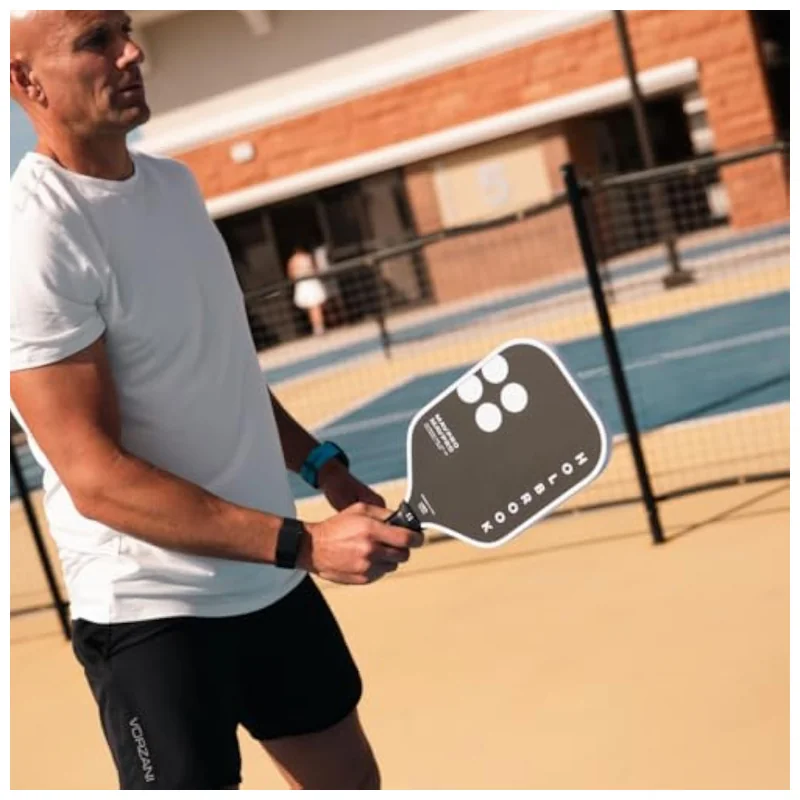 Mav Pro 2.0 paddle held in hand showing ergonomic comfort grip and pink accent edge guard